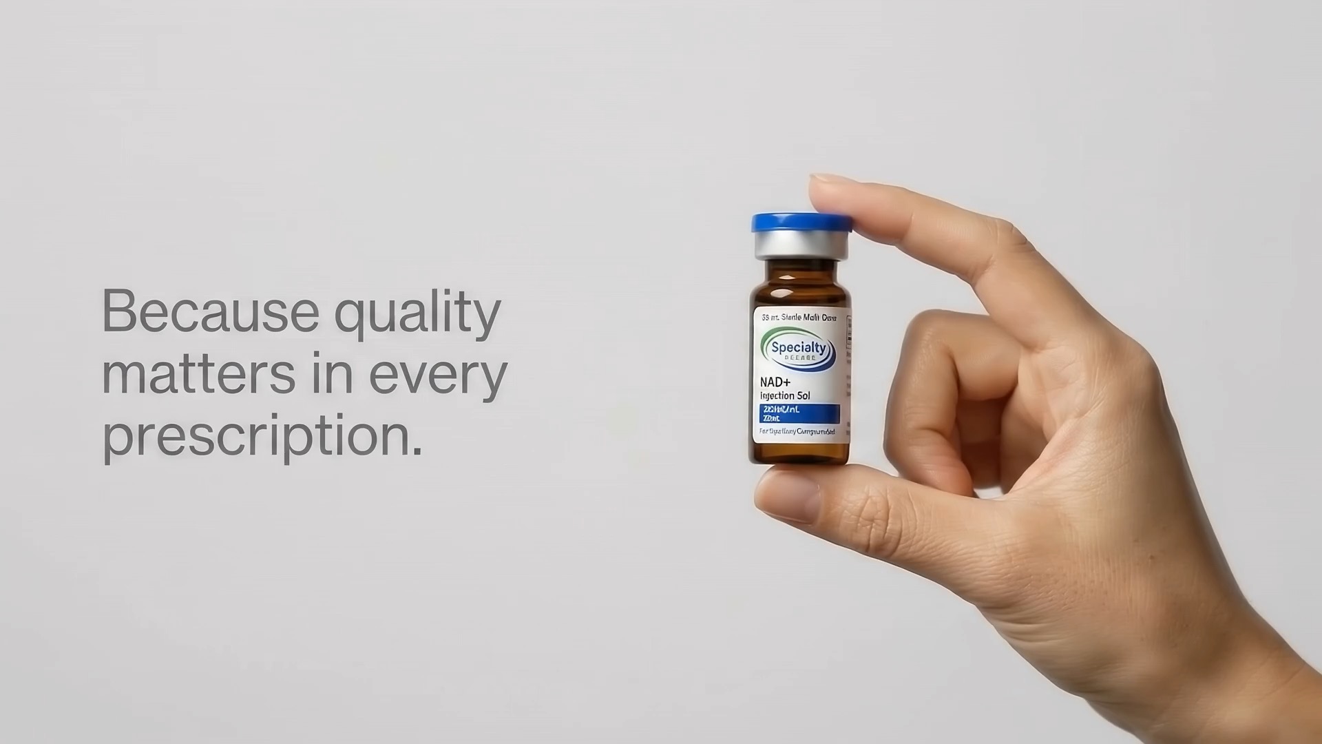 A hand holding a Specialty Rxcare compounded vial